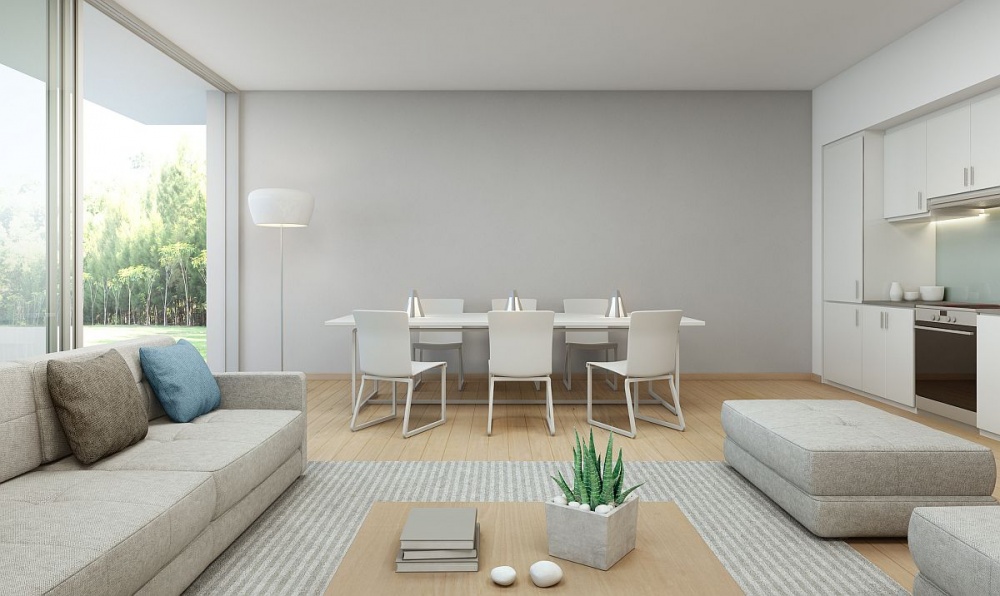 Grau-weisse offene Wohnküche mit Esstisch und Couchgarnitur